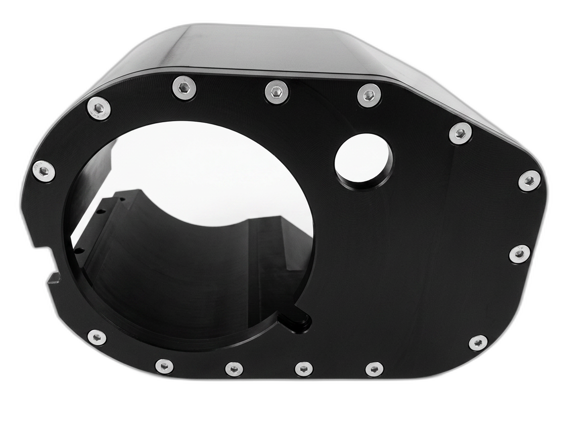 Black machined plastic housing with circular bore and threaded inserts
