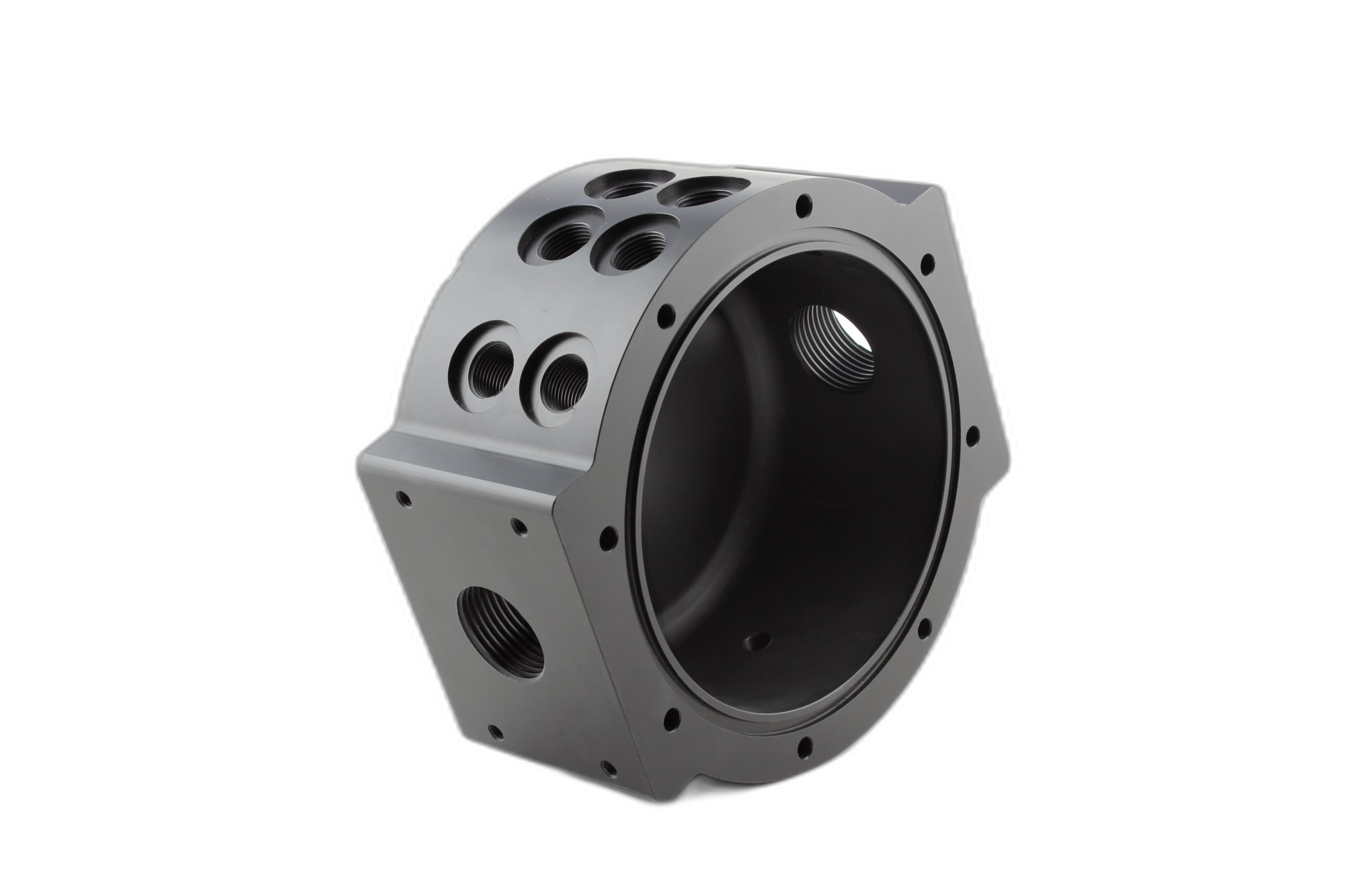 Black machined plastic cylindrical housing with multiple threaded ports